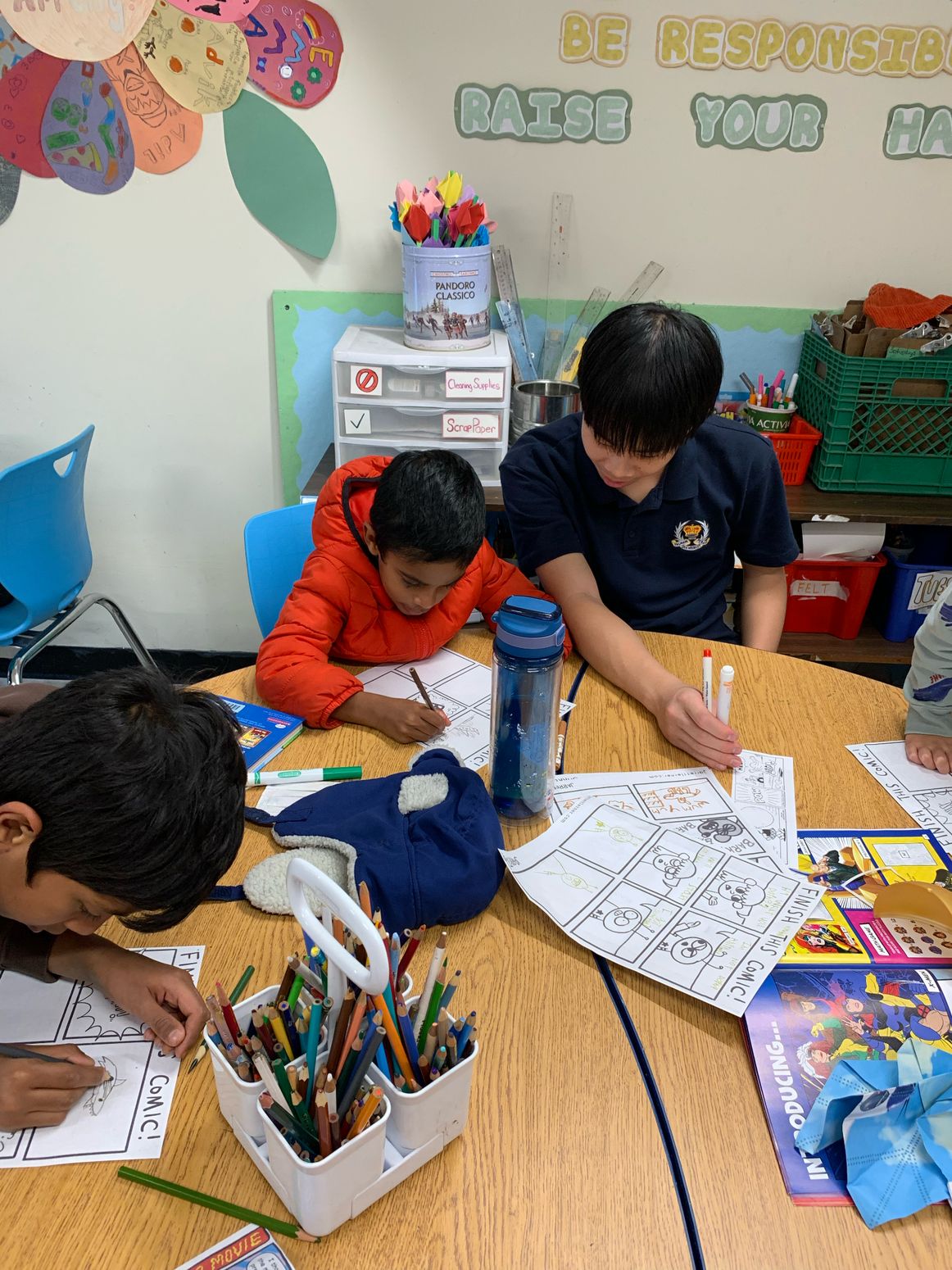 Hands & Canvas volunteer creating alongside children at an in-person workshop