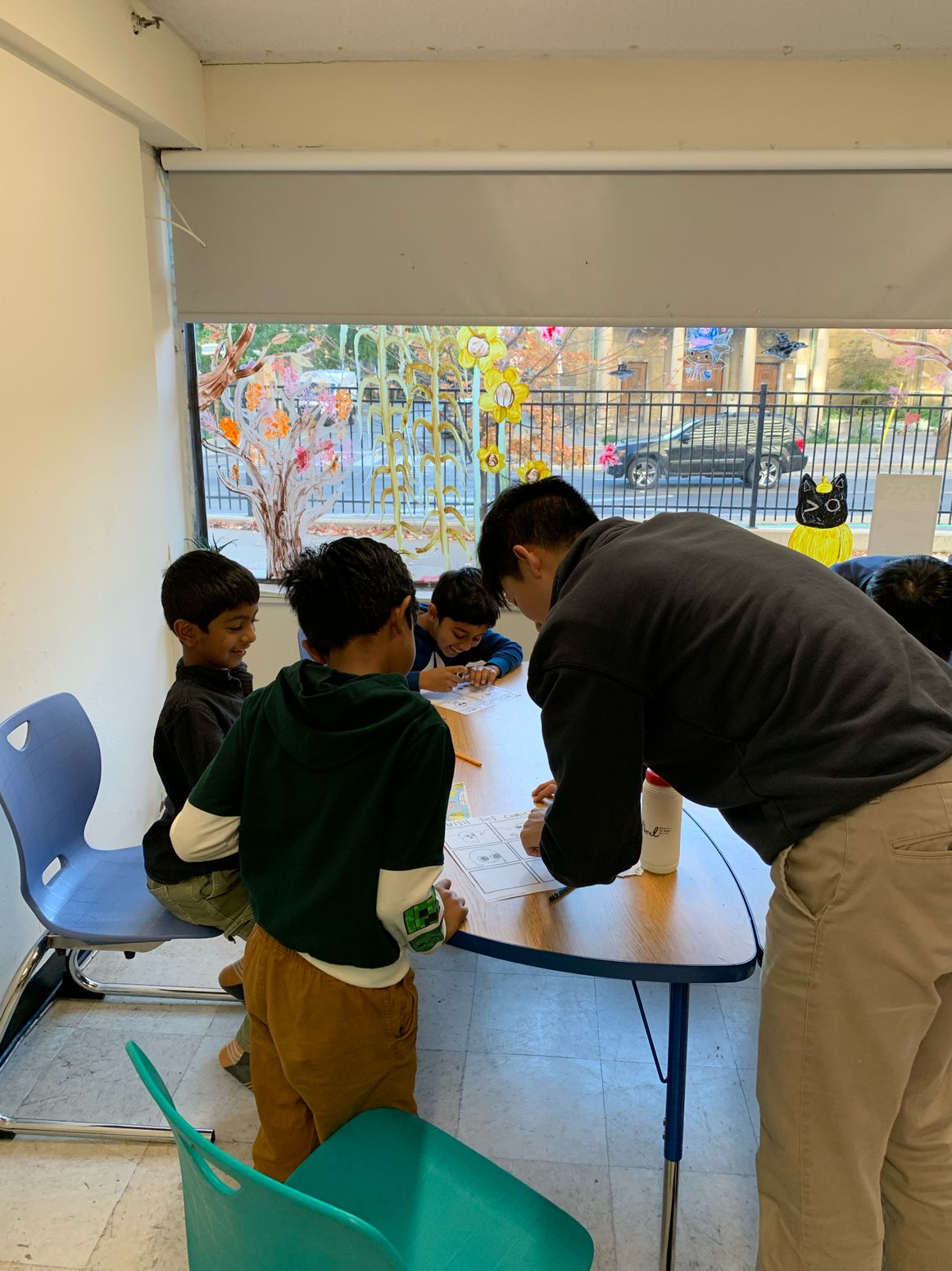 Small group drawing together near a classroom window