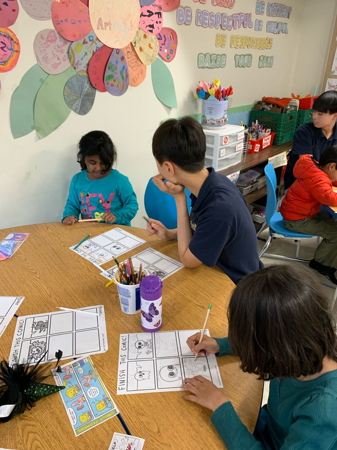Children and volunteers working on drawing activities