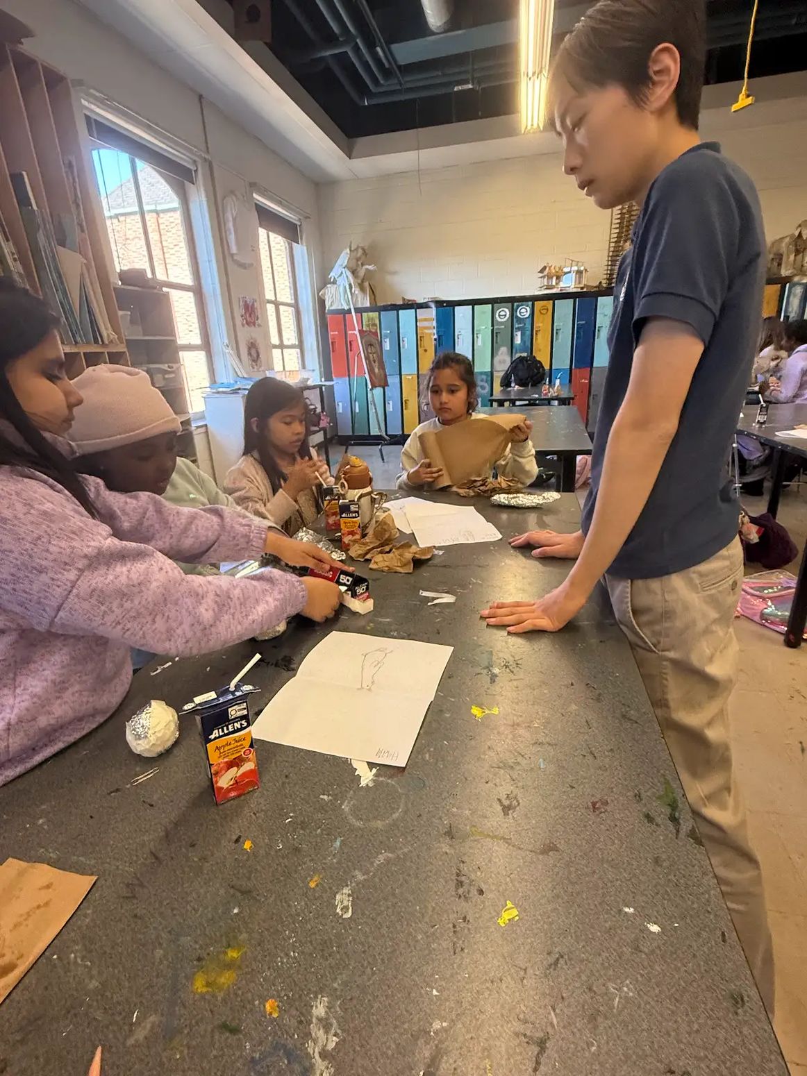 Volunteer helping at a workshop table