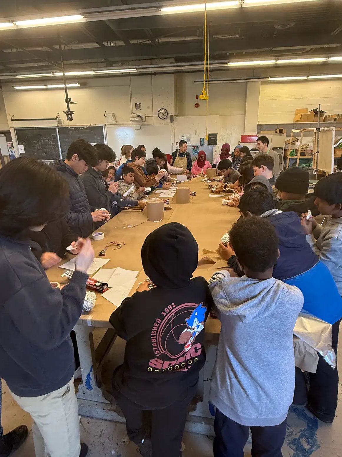 Large community art workshop around a long table